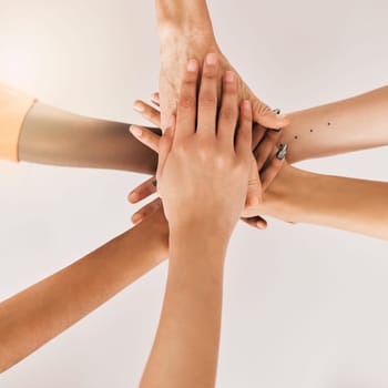 Hands stacked, teamwork and women in support, collaboration goals and community or solidarity from above. Circle, group of people and team work, faith or together sign isolated on a white background.
