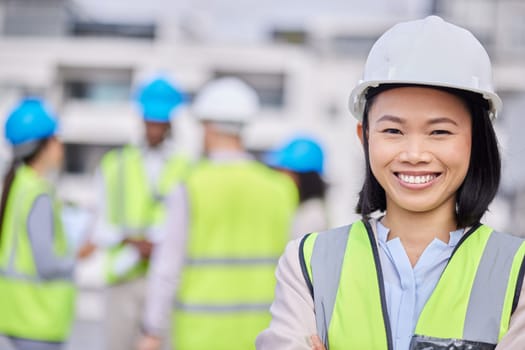 Engineering, leadership and portrait of a woman construction worker on an outdoor site. Confidence, happy and Asian female industry manager or foreman standing with crossed arms on a building plot.