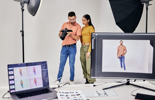 Collaboration, photographer and startup people in studio set with camera for shoot, magazine project or online content. Planning or teamwork examine picture for digital catalog or fashion web design