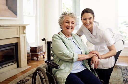 Shes my favorite patient. Portrait of a caregiver with a senior woman in a wheelchair at home.