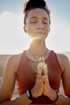Yoga, pray hands and zen meditation or mental health in sunshine outdoors. Young woman relax, fitness and peace chakra or faith worship praying for balance, mindfulness and spiritual breathing