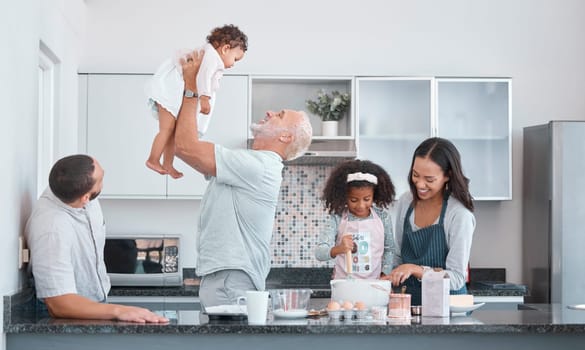 Family, children and baking with a senior man bonding with his granddaughter in the kitchen of a home. Love, grandparent and diversity with a mother and daughter learning to bake for cooking