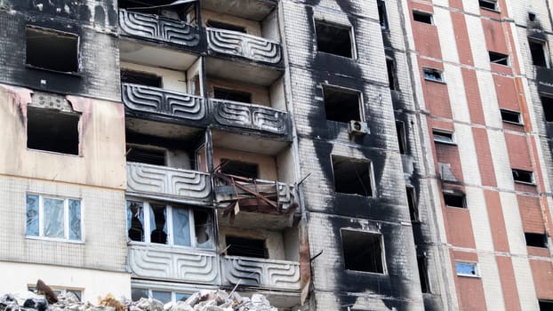 Residential buildings, windows and balconies were damaged by the blast and shrapnel from artillery shelling. The destruction of the city by military operations, the consequences of the war.
