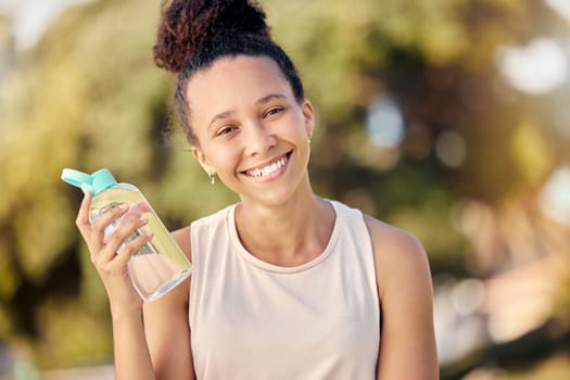 Water bottle, fitness and nature of black woman in portrait for outdoor exercise, wellness and healthy diet lifestyle in park or forest. Trees bokeh, workout and sports girl with drinking water gear