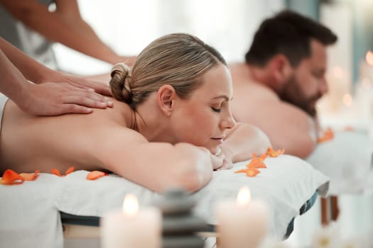 Couple, spa massage or relax wellness in peace, healthcare or reiki hotel salon in self care, muscle tension or stress. Masseuse hands, woman or man on luxury honeymoon table bed in zen pamper space