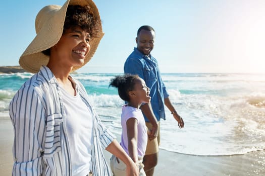 Happy family, summer and beach walk by parents and child on vacation or holiday at the ocean or sea. Travel, mother and father with African daughter or kid holding hands together near water