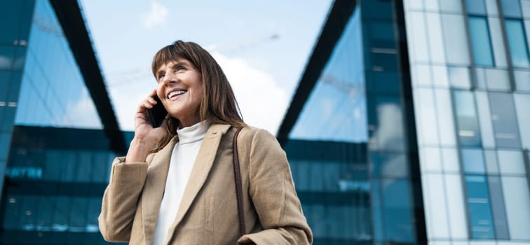 Business woman, phone call and smile for communication, networking and conversation with contact or investor outdoor by office buildings. Happy entrepreneur with smartphone with 5g network connection.