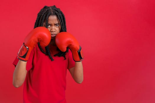 African woman with boxing gloves in fight pose