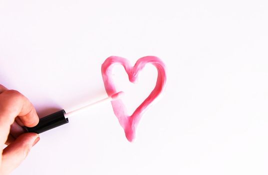 Pink lip gloss on a white background.