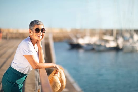 Cheerful European Senior Woman Standing At Marina Pier Outdoors, Copyspace