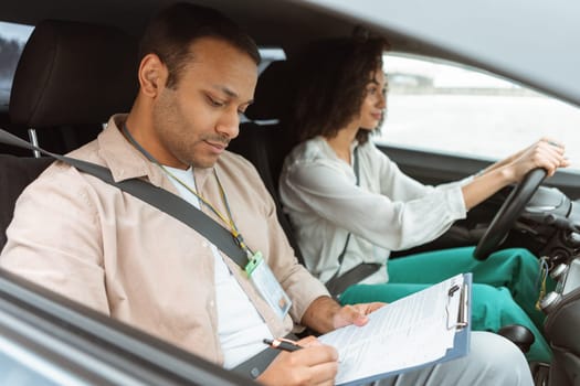 Arabic Instructor Taking Notes Teaching Novice Driver Woman Driving Car