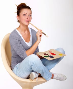 Thinking, painting and art ideas in studio for creativity, talent and a paint brush for color. Female artist or painter person isolated on a white background for creative work or project to relax