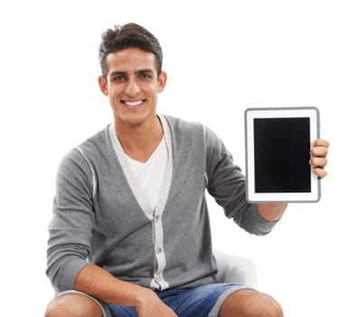 Proud of his new tablet. Portrait of handsome young man holding up an ipad and smiling against a white background.