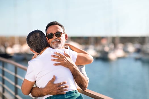 Senior Family Couple Shares Hug And Joy At Marina Outside