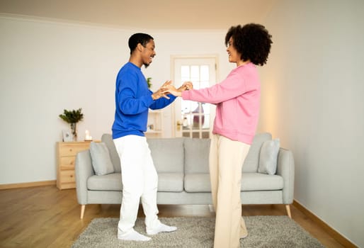Loving African American Spouses Enjoying Dance Session At Home