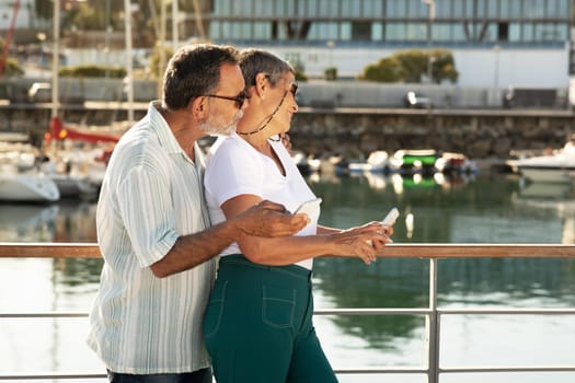 Side View Of Happy Mature Couple Embracing At Marina Pier