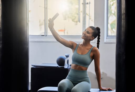 Fitness, gym and woman taking selfie with phone in home studio for social media post, wellness blog and network. Health, sports and happy girl with smartphone after exercise, workout and training