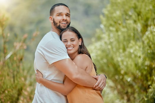 Black couple, hug and smile in woods together, outdoor and bush with love, romance or bonding on vacation in nature. Happy, man and woman embrace in portrait, forest or trees for happiness.