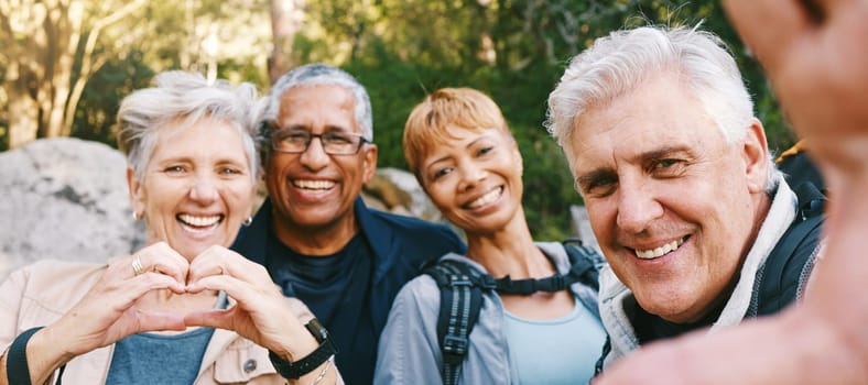 Nature, selfie and senior friends hiking together in a forest while on an outdoor adventure. Happy, smile and portrait of a group of elderly people trekking in woods for wellness, health and exercise.