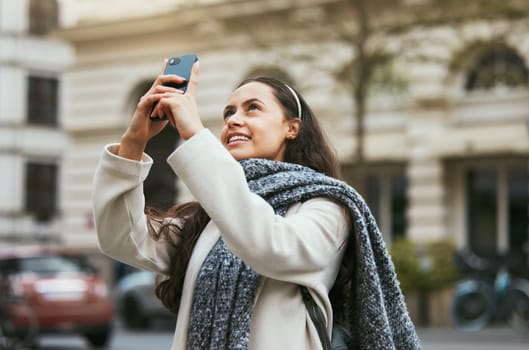 Travel, tourist and photograph with a woman in the city taking a picture while traveling abroad on holiday or vacation. Phone, tourism and mobile with a female traveler while sightseeing overseas