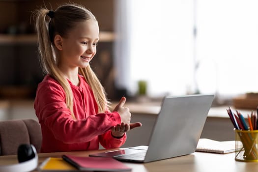 Virtual Tutoring. Cute Little Girl Using Laptop, Having Online Lesson With Tutor