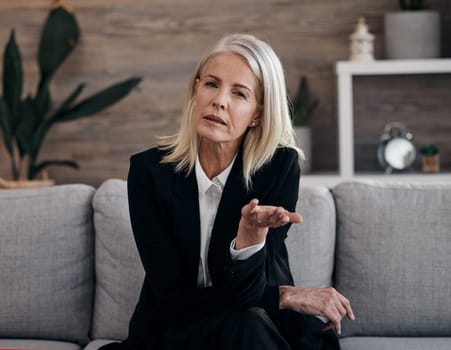 Business therapist, psychology communication and portrait of a mature woman sitting on a couch. Mental wellness worker, psychologist and life coach doing a counseling consultation on a office sofa
