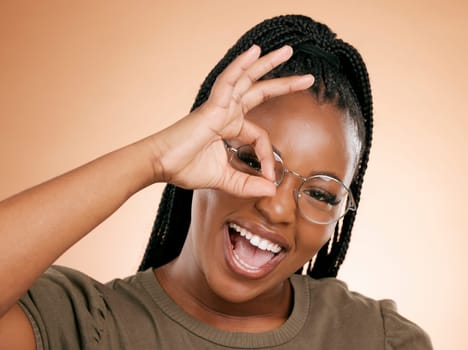 Black woman, portrait smile and ok hand sign for perfect, great or right against studio background. Happy African American female smiling in happiness showing okay emoji gesture for positive attitude