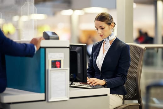 Airport, check in desk and woman typing for security, identity and travel documents for border immigration service. Concierge, customer service and help for global transportation with pc on table