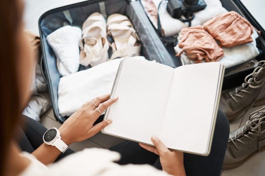 Travel, suitcase and notebook with hands of woman for planning, vacation and packing clothing. Journey, luggage and adventure with journal planner and traveller for holiday, tourism and abroad trip