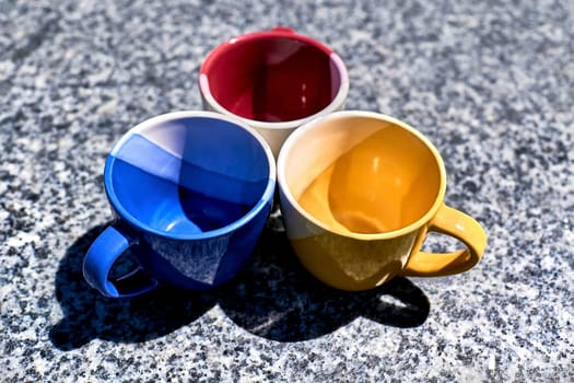 Time of ceremony for tea and coffee.Colorful cups on gray marble surface