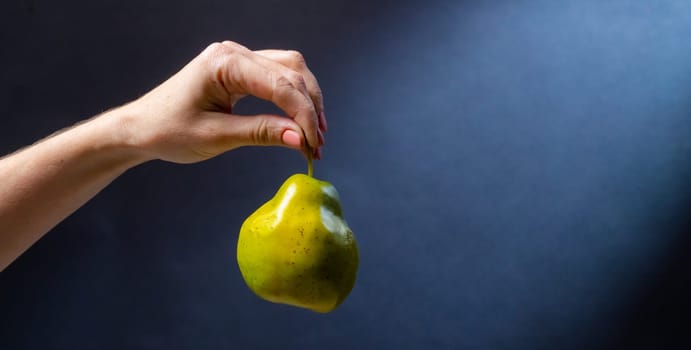 Hand holding pear