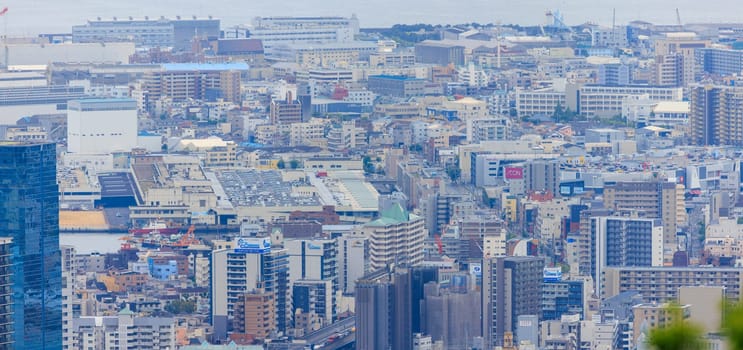 Kobe, Japan - May 20, 2023: Looking down on office buildings and apartments in city center. High quality photo