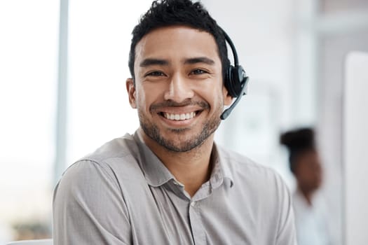 Happy asian man, call center and portrait smile with headphones in customer service or telemarketing at office. Face of businessman consultant agent smiling in online advice or telesales at workplace