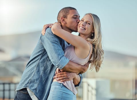 Interracial man and woman, love and kiss outside feeling happy, in love and caring in the city. Romance, romantic and boyfriend and girlfriend embracing, hugging and kissing with affection in town