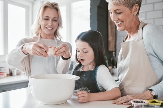 .Family, baking and bonding for development and learning for culinary skills in the family home. Mother, grandmother and daughter cook or cooking in house with eggs for food for hunger or snack.
