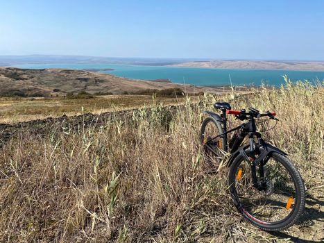 Bike standing on a hill near lake. Panoramic aerial view