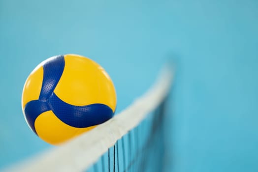 Blurred photo in action of a volleyball near the net