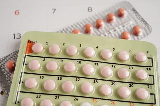 Birth control pills for female on calendar, ovulation day.