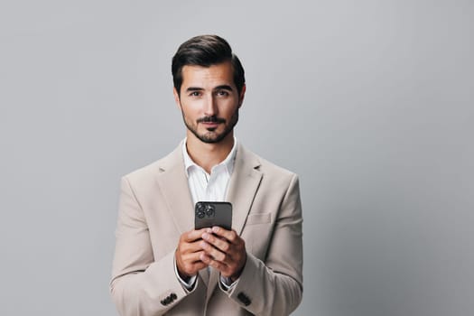 portrait man smartphone phone call white business smile communication corporate holding application cellphone suit app happy beige hold online technology gray