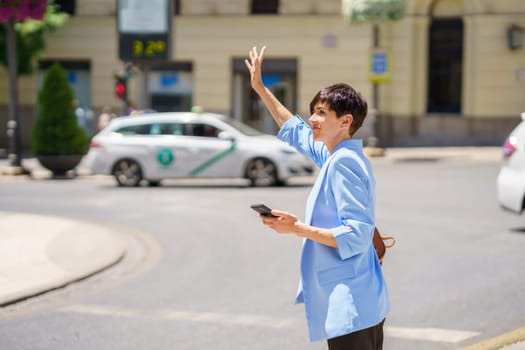 Focused woman with smartphone catching ride on city street