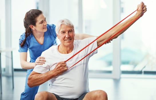 Im ready to battle against old age. Cropped portrait of a senior man working on his recovery with a female physiotherapist.