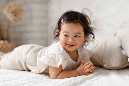 Cute Korean Baby Girl Posing Lying On Stomach At Home