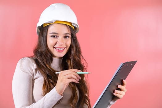 Brown-haired woman in hardhat with smile prepares project