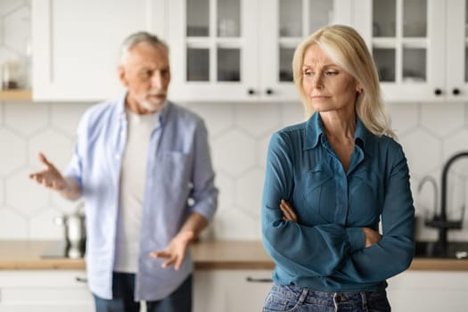 Relationship Crisis. Portrait Of Senior Spouses Arguing In Kitchen Interior