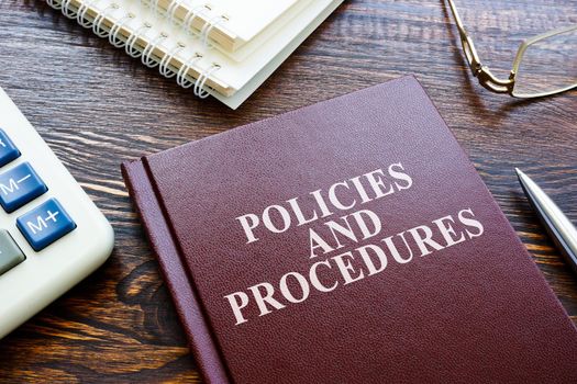 The policies and procedures guide on table.