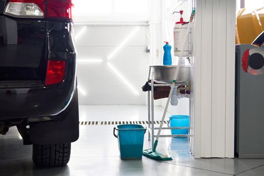cleaning floor in car workshop, keeping work place clean