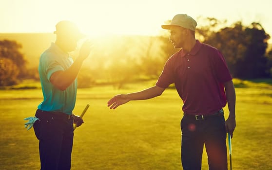 The toughest opponent is your own ego. two golfers about to shake hands on the golf course.