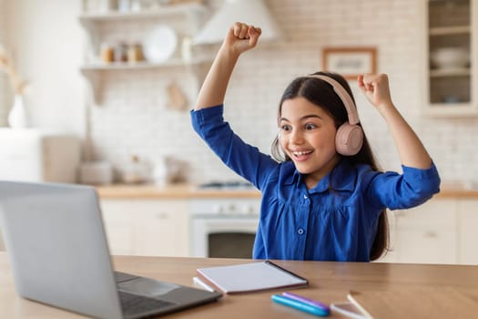 Joyful School Girl Learning Online And Celebrating Great News Indoor