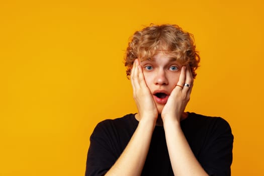 Young man over yellow background with surprise facial expression