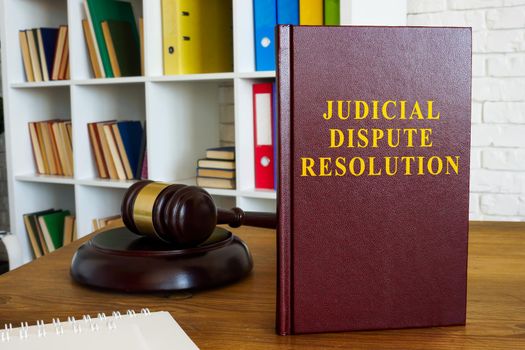 Judicial dispute resolution book on the desk.
